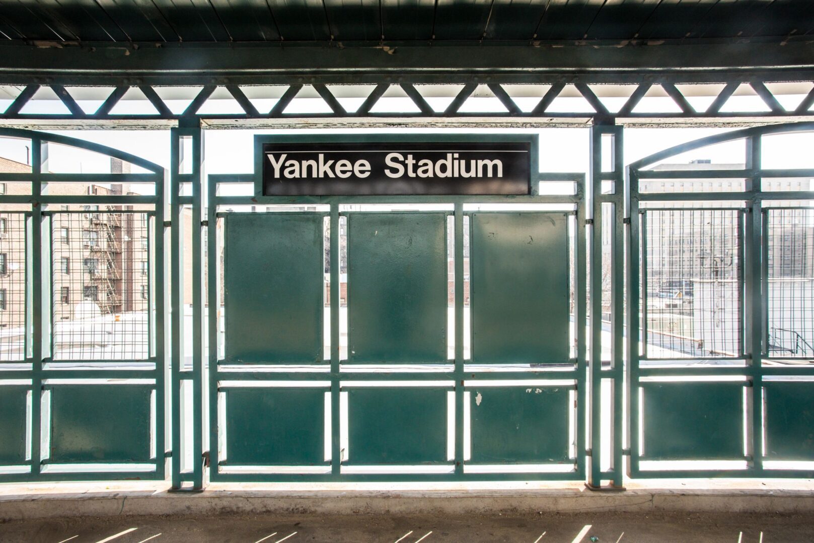 Symmetrical station fence framing Yankee Stadium sign