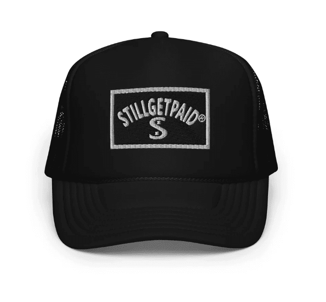 Black baseball cap with Stillgetrap logo patch on the front.